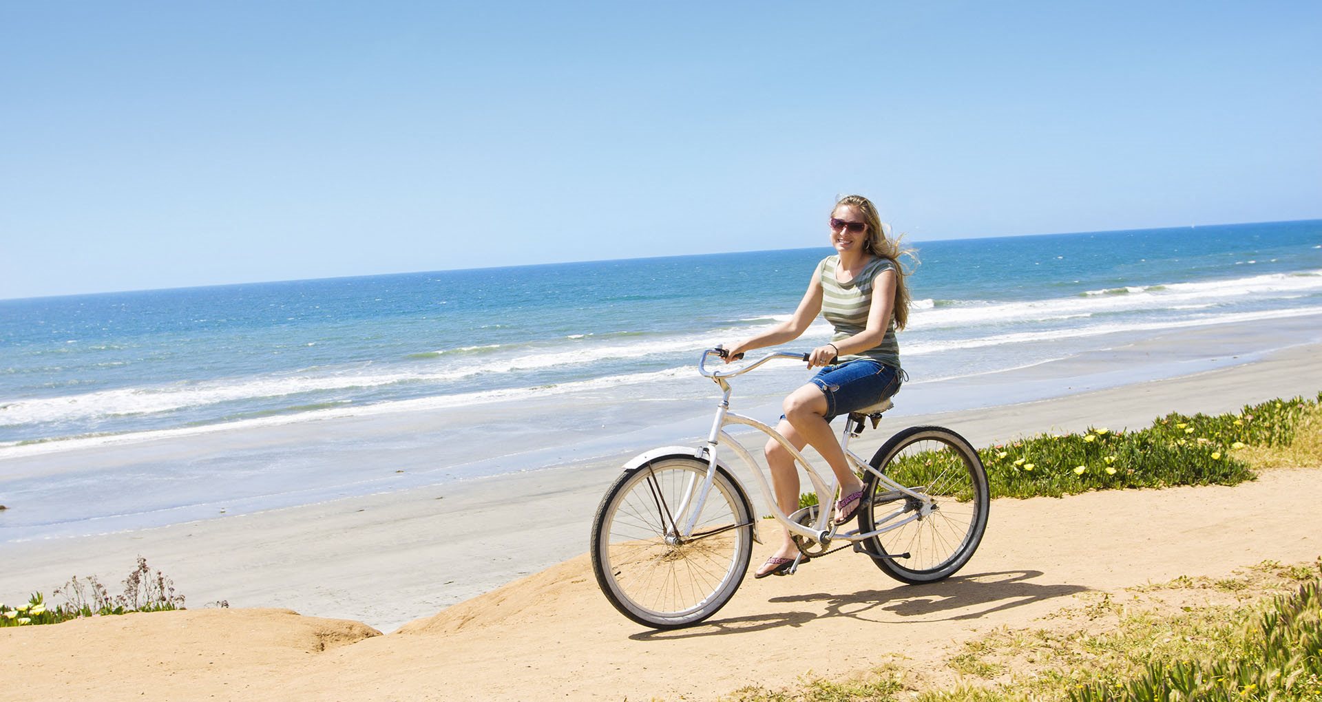 Girl on bike by beach Pointe at 2316 Apts  for rent in Oceanside CA